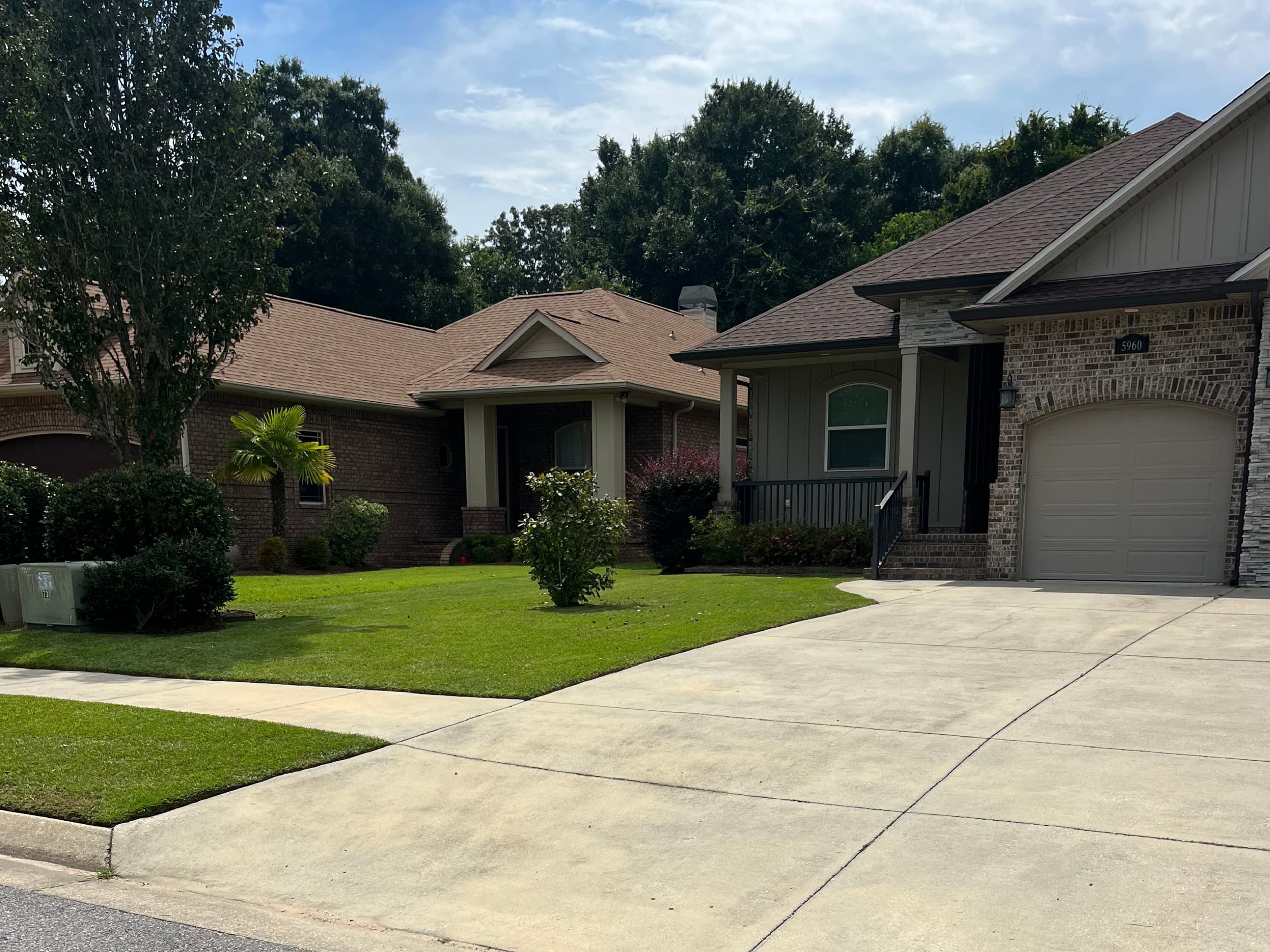 Freshly maintained lawn and driveway by Stokes Lawn Care in Pensacola, Florida